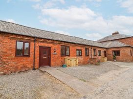 An exterior view of a brick building with a door and windows at Elwy Cottage St. Asaph