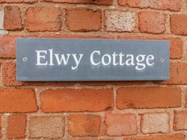A sign reading Elwy Cottage on a brick wall at Elwy Cottage St. Asaph