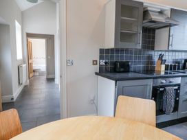 A kitchen with a table and chairs at Elwy Cottage in St. Asaph