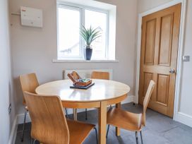A dining room with a table and chairs at Elwy Cottage in St. Asaph