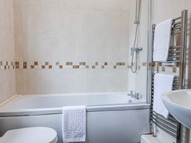A bathroom with a bathtub and sink at Elwy Cottage in St. Asaph