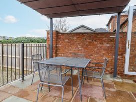An outdoor seating area with a table and chairs at Elwy Cottage St. Asaph