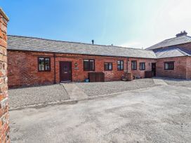 An outdoor area with a brick building and gravel pathway at Elwy Cottage in St Asaph
