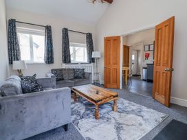 A living room with a sofa and coffee table at Elwy Cottage St Asaph