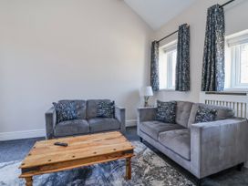 A living room with sofas and a coffee table at Elwy Cottage St Asaph