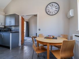A kitchen with a dining table and chairs at Elwy Cottage St Asaph