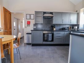 A kitchen with cabinets and appliances at Elwy Cottage, St Asaph
