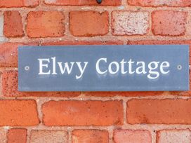 A nameplate on a brick wall at Elwy Cottage in St Asaph