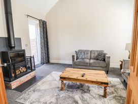 A living room with a sofa and coffee table at Elwy Cottage in St Asaph