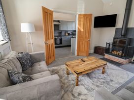 A living room with a sofa and a coffee table at Elwy Cottage St Asaph