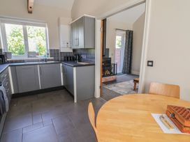 A kitchen with a table and chairs at Elwy Cottage in St Asaph