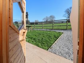 An outdoor area with a view of grass and a fence at Antlers Lodge in Biddulph Moor