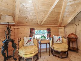 A snug with chairs and a table at Antlers Lodge in Biddulph Moor