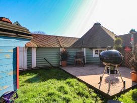 A garden with a grill and seating area at Antlers Lodge in Biddulph Moor