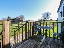 An outdoor area with a table and chairs at Shepherds Delight in Biddulph Moor