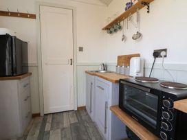 A kitchen with a sink and an oven at Shepherds Delight in Biddulph Moor