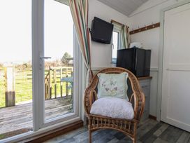 A snug with an armchair and television at Shepherds Delight in Biddulph Moor