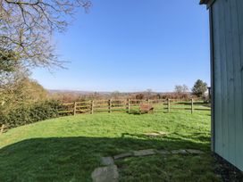 A garden with a wooden bench and a stone path at Shepherds Delight in Biddulph Moor
