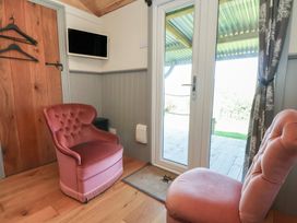 A seating area with chairs and door at Golden Fleece in Biddulph Moor