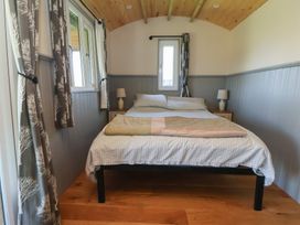 A bedroom with a bed and lamp at Golden Fleece in Biddulph Moor
