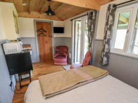A bedroom with a bed and chair at Golden Fleece in Biddulph Moor