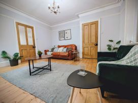 A living room with a sofa, coffee table and potted plant at 4 The Croft Hexham