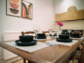 A dining room setup with plates and glasses on the table at 4 The Croft in Hexham