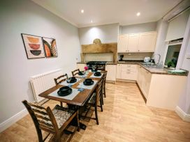 A kitchen with a dining table and chairs at 4 The Croft in Hexham