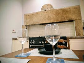 A kitchen with an oven and glassware at 4 The Croft in Hexham