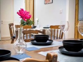 A dining room with a table set for meals at 4 The Croft in Hexham