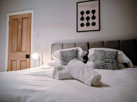 A bedroom with a bed and a bedside lamp at 4 The Croft in Hexham