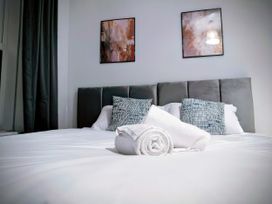 A bedroom with a bed and pillows at 4 The Croft Hexham