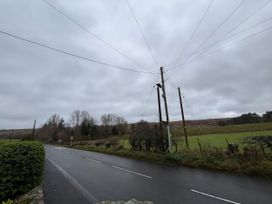 A road with electric poles and fields at 4 The Croft in Hexham