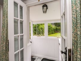An entryway with a door and windows leading to a garden at 3 Tre Felin Llandygai near Bangor