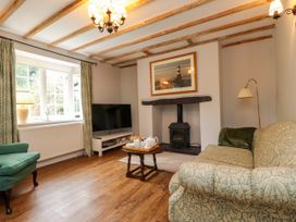 A living room with a sofa and fireplace at 3 Tre Felin in Llandygai near Bangor