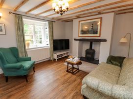A living room with a sofa and an armchair at 3 Tre Felin in Llandygai near Bangor