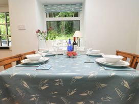 A dining table set with plates and glasses at 3 Tre Felin in Llandygai near Bangor