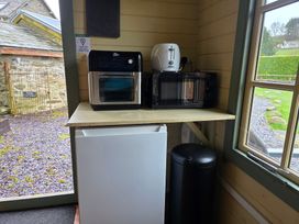 A kitchen area with appliances at Cwt Tyddyn Shepherd's Hut Cefn Brith near Cerrigydrudion