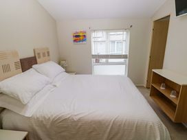 A bedroom with a bed and nightstand at Wernlas Lodge in Oxwich