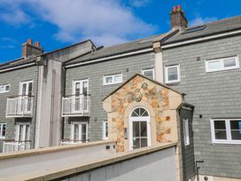 An exterior view of a building with balconies and a stone entrance at 21 Compass Point, Carbis Bay