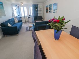 A living room with a sofa and table at 21 Compass Point in Carbis Bay