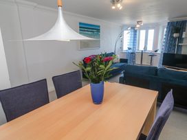 A dining room with a table and chairs at 21 Compass Point Carbis Bay
