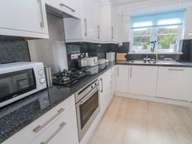 A kitchen with appliances and fixtures at 21 Compass Point in Carbis Bay