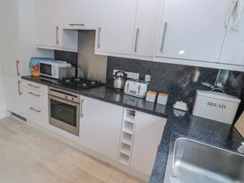 A kitchen with various appliances and storage at 21 Compass Point Carbis Bay