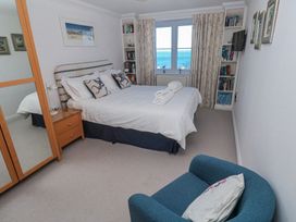 A bedroom with a bed and bookshelf at 21 Compass Point in Carbis Bay