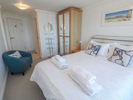 A bedroom with a bed and a chair at 21 Compass Point, Carbis Bay