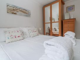 A bedroom with a bed and wardrobe at 21 Compass Point, Carbis Bay