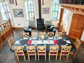 A dining room with a large table and chairs at Kaber Chapel near Kirby Stephen