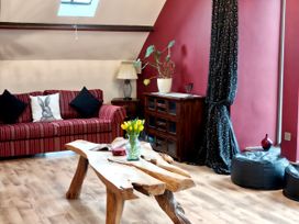 A living room with a sofa and a coffee table at Kaber Chapel in Kaber near Kirby Stephen