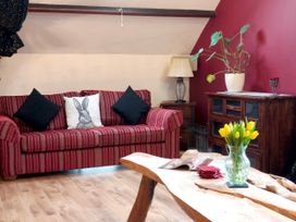 A living room with a sofa and a table at Kaber Chapel in Kaber near Kirby Stephen